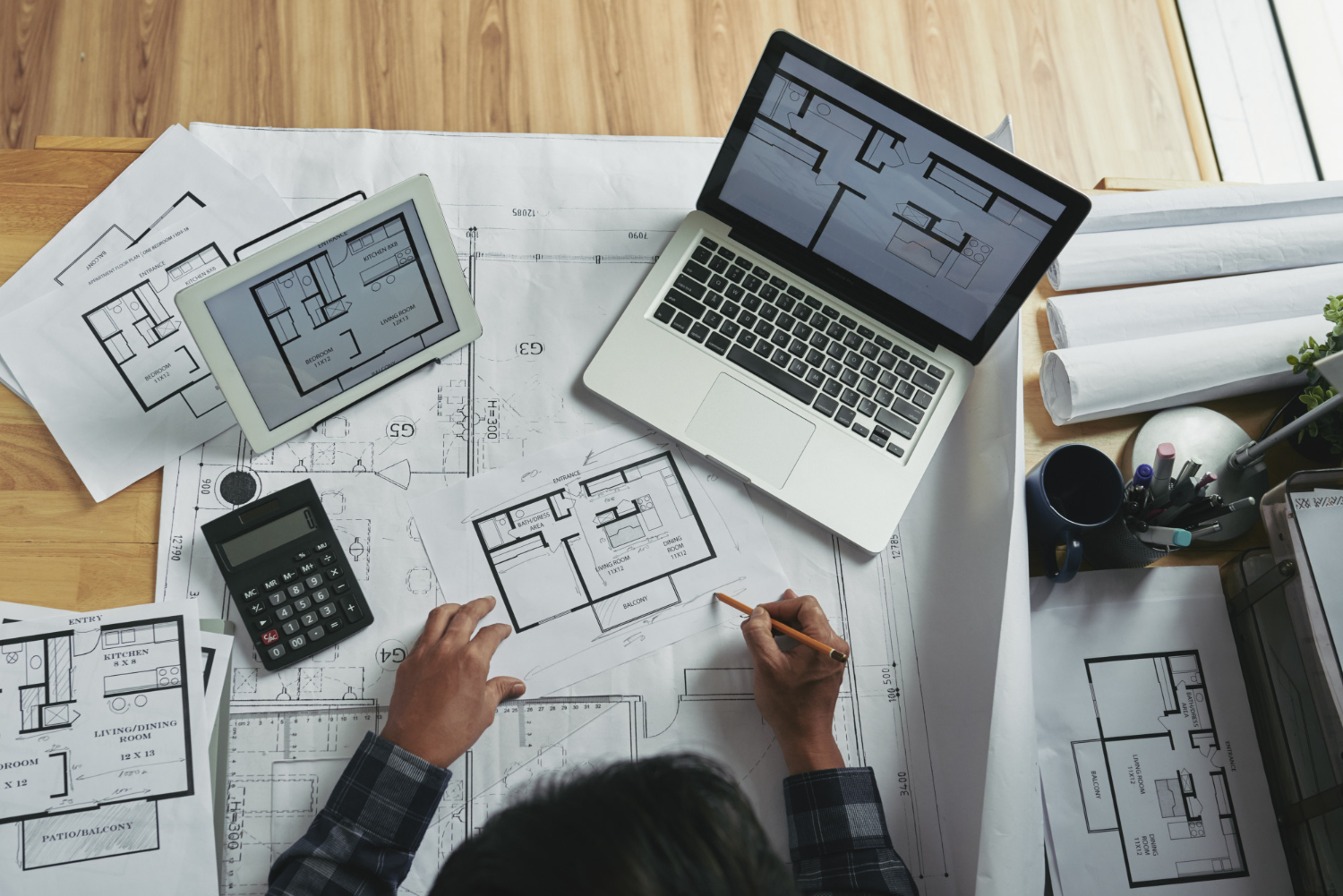 top-view-unrecognizable-person-making-corrections-blueprint-sketch